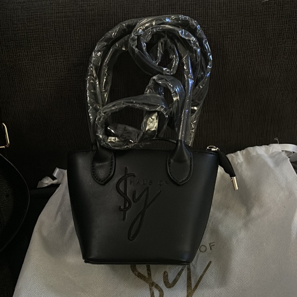 Mini Haus of Sy tote it’s really small comes with a strap also - Picture 3 of 3